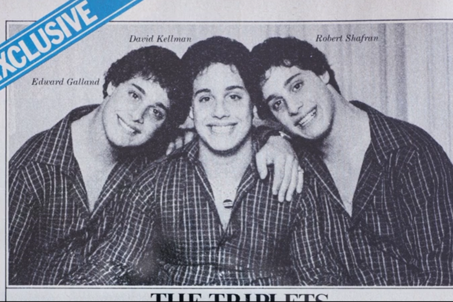 Black-and-white magazine photo labeled "EXCLUSIVE" featuring triplets Edward Galland, David Kellman, and Robert Shafran smiling and leaning into each other, all wearing matching checkered shirts. Their names are printed above each of their heads.