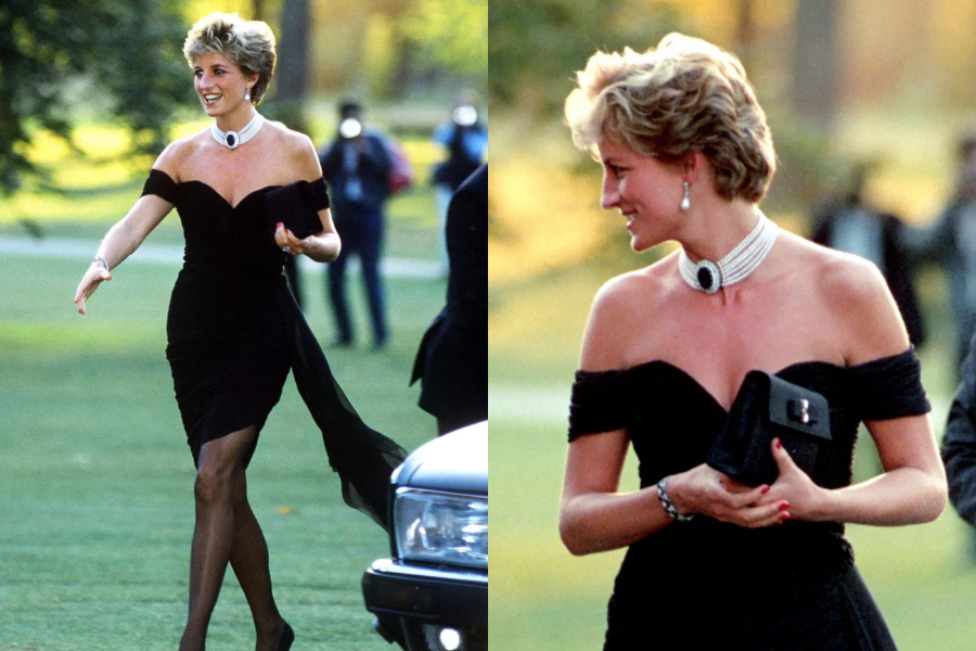 A woman elegantly steps out in a striking off-the-shoulder black cocktail dress with a high slit, famously known as the “revenge dress.” She pairs the outfit with sheer black tights, heels, a bold multi-strand pearl choker with a large sapphire and diamond centerpiece, and a black clutch, smiling confidently as she arrives at an evening event.