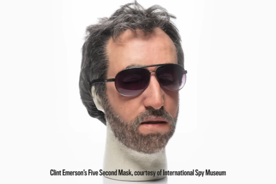 Realistic silicone disguise known as “Clint Emerson’s Five Second Mask,” featuring a full male face with dark sunglasses, graying hair, and a trimmed beard, displayed on a white mannequin head against a plain background. The mask is designed for rapid identity concealment.