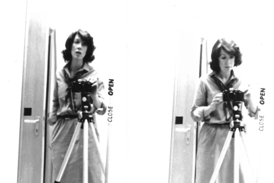 Black and white diptych image showing a woman in a belted dress taking a mirror self-portrait with a camera mounted on a tripod. On the left, she looks directly into the mirror; on the right, she adjusts the camera while looking down, with the words “CLOSE” and “OPEN” visible along the mirror’s edge.