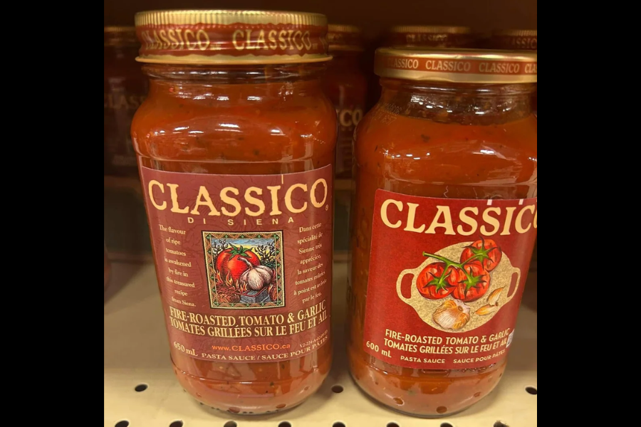 Two jars of Classico Fire-Roasted Tomato & Garlic pasta sauce on a store shelf, with slightly different label designs and sizes.