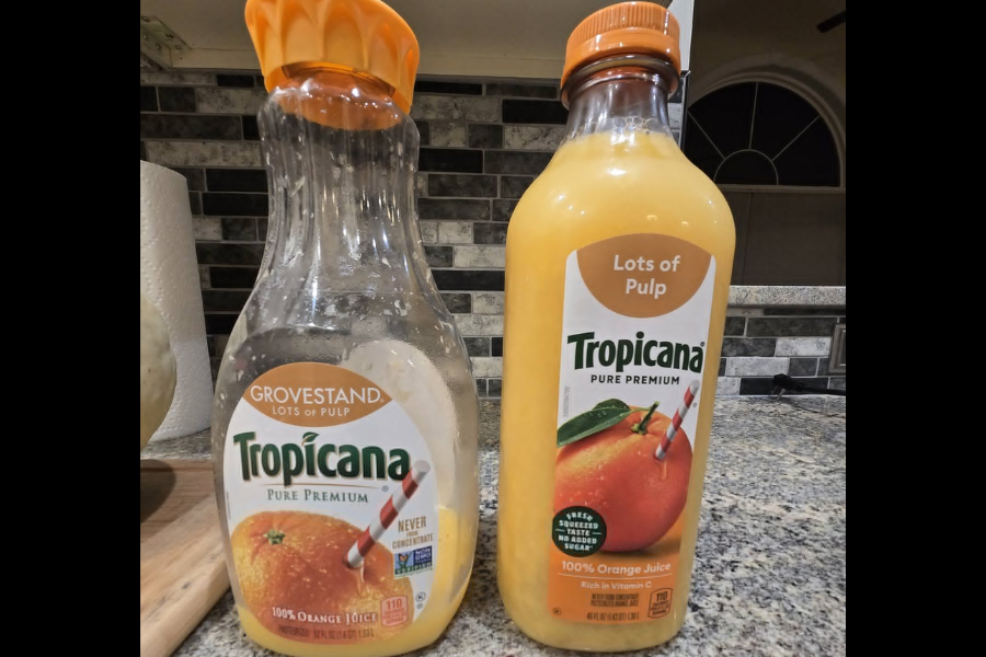 Two Tropicana Pure Premium orange juice bottles labeled “Lots of Pulp,” one older Grovestand style and one newer, with visible packaging redesign.
