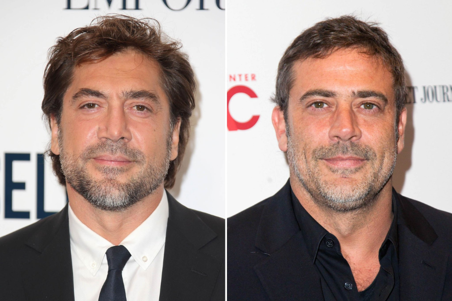 Side-by-side photo of two men with short dark hair and trimmed beards, both wearing dark suits and smiling subtly at the camera. The man on the left wears a white shirt with a black tie, while the man on the right has an open-collared black shirt.