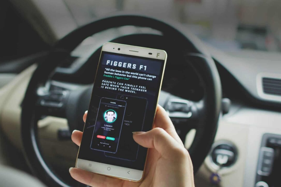 A smartphone screen displays the "FIGGERS F1" interface with a quote and image of a caller named Lowson, held inside a parked car.