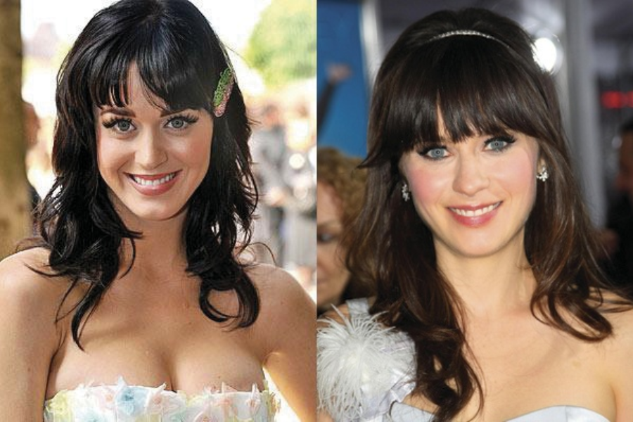Side-by-side photo of two women with long dark wavy hair and bangs, both smiling at the camera. The woman on the left wears a strapless pastel dress with a hair clip, while the woman on the right wears a strapless white dress with feather detail and a thin headband.