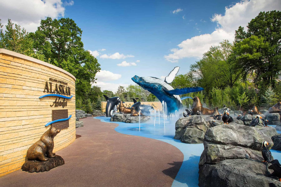 The Alaskan Adventure splash pad at the Minnesota Zoo features lifelike sculptures of puffins, seals, whales, and a bear around water jets and mist.