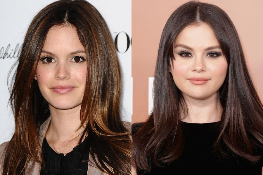 Side-by-side close-up of two women with straight dark brown hair, both looking at the camera with subtle smiles. The woman on the left poses in front of a white backdrop with text, while the woman on the right is in front of a warm-toned background.