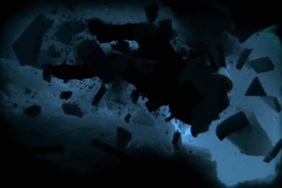 silhouetted figure falls into darkness surrounded by chunks of broken ice, suggesting a dramatic accident or crevasse fall.