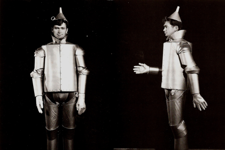 Black and white side-by-side photos of a man wearing a rigid Tin Man costume from an early screen test