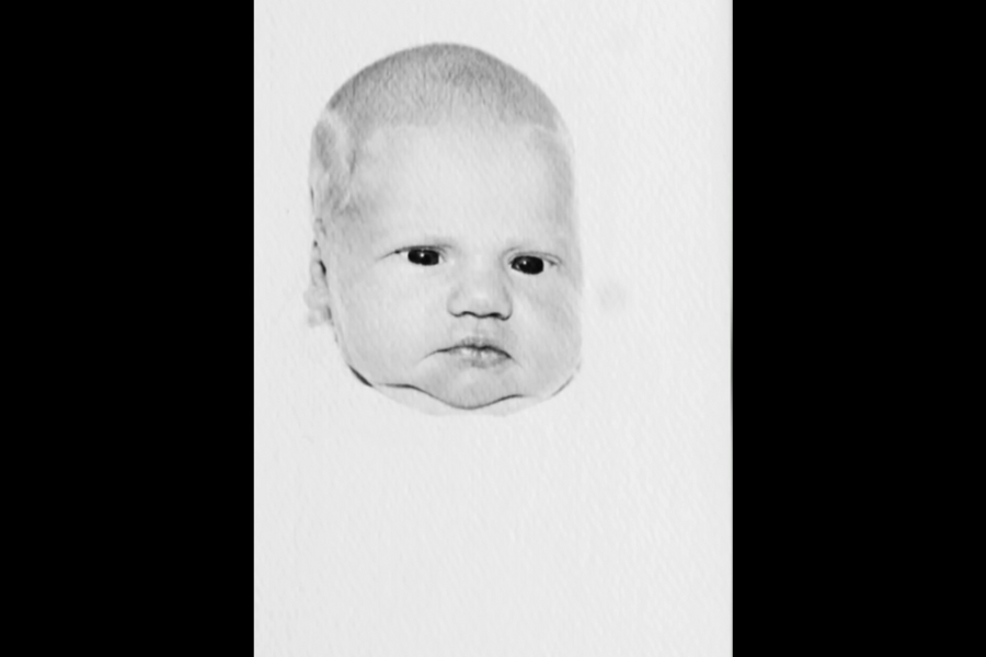 Black and white photo of a newborn baby’s face, centered against a plain background.