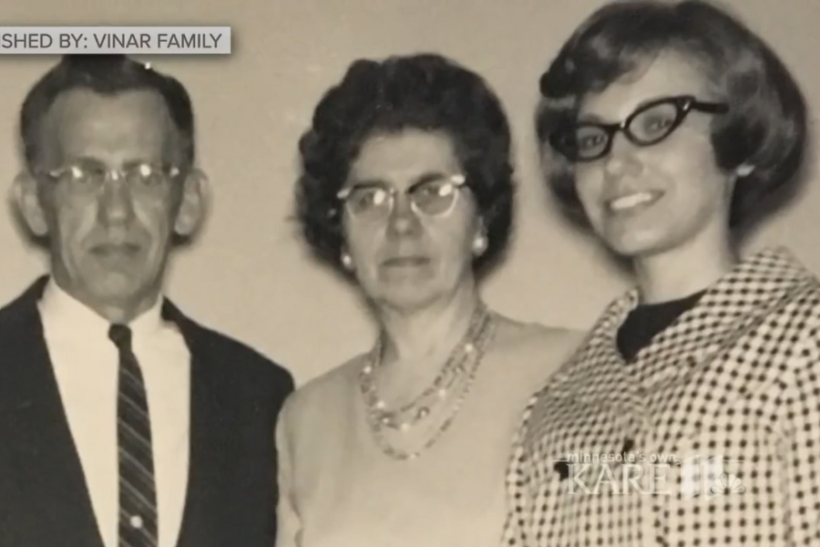 Black and white family photo of three people, with a man in glasses, a woman in a necklace, and a young woman in patterned clothing.