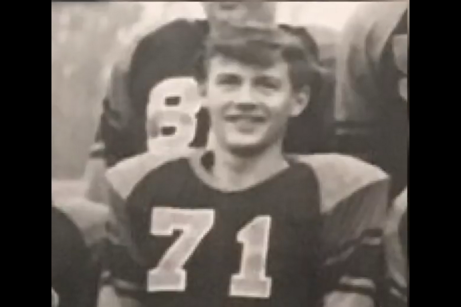 Vintage black and white football team photo, focusing on a smiling player wearing jersey number 71.