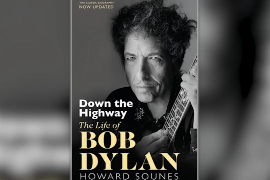 Book cover of "Down the Highway: The Life of Bob Dylan" by Howard Sounes, featuring a grayscale photo of Dylan holding a guitar and looking intently forward.