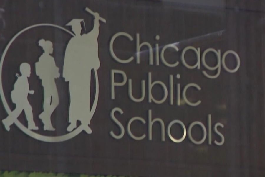 Chicago Public Schools logo displayed on a building, featuring silhouettes of students and a graduate in a circle beside the text.