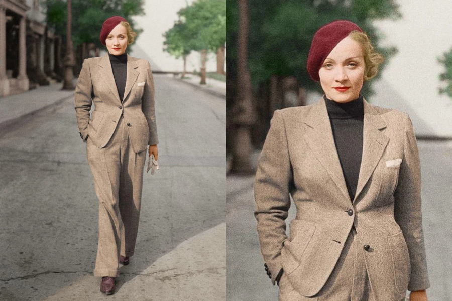 Woman confidently walking down a tree-lined street in a tailored tan suit and maroon beret, with a black turtleneck underneath. Close-up captures her bold red lipstick and structured styling.