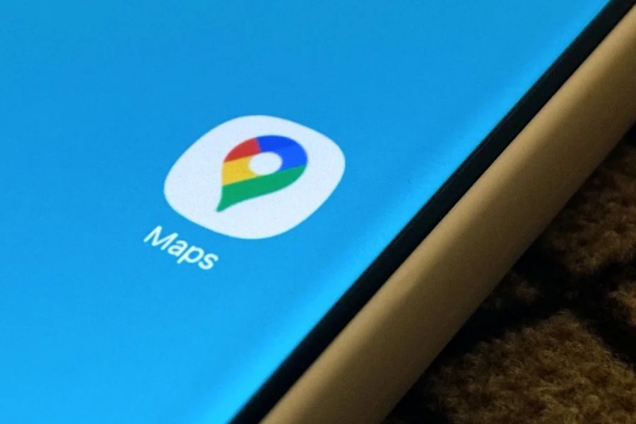 Close-up of a smartphone screen showing the Google Maps app icon against a blue background.