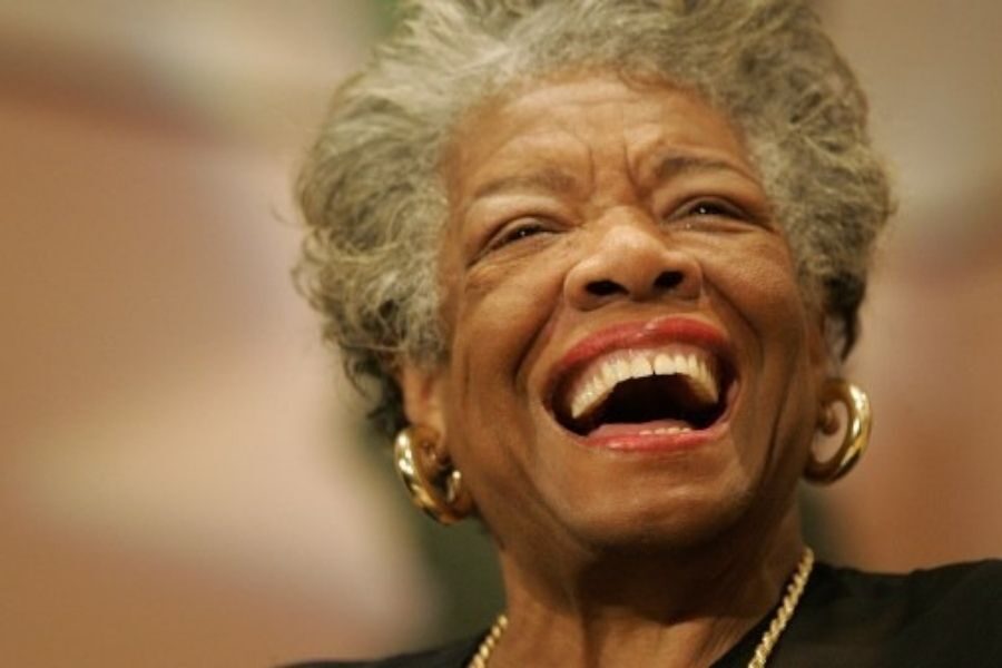 Elderly woman with short gray hair, wearing earrings, laughing joyously. Her expression conveys happiness and warmth, radiating positive energy.