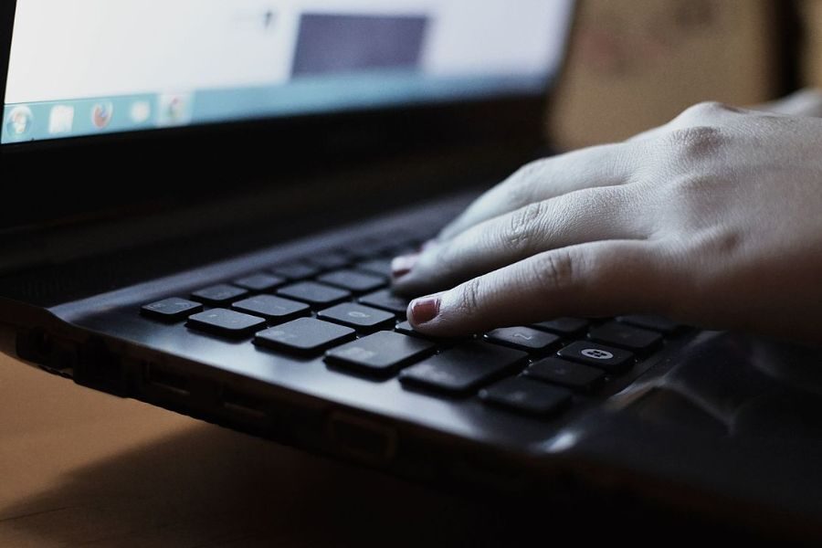 Female hands on laptop keyboard