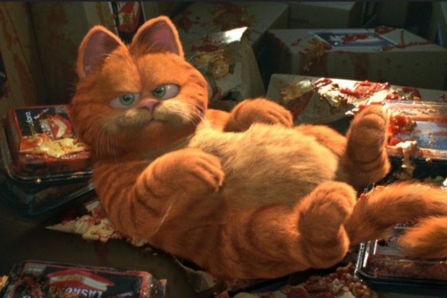 A chubby, animated orange cat lounges lazily among takeout containers with a mischievous expression. Remnants of food are scattered around.