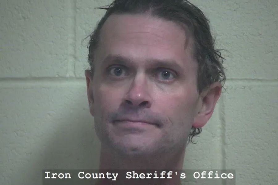 Mugshot of a man in a detention facility with “Iron County Sheriff's Office” captioned at the bottom of the image.
